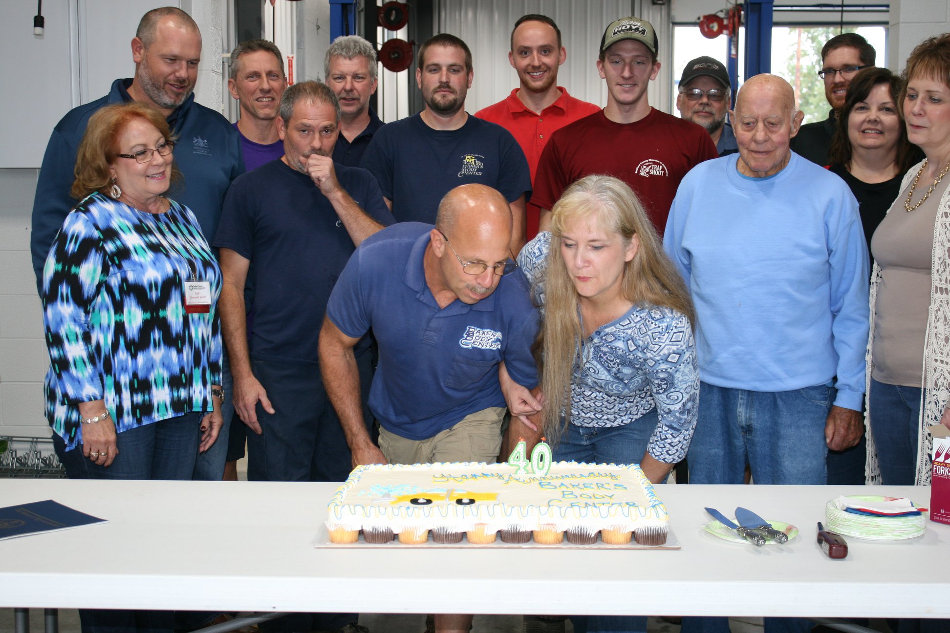 Baker's Body Center staff blowing out candles for 40th anniversary party