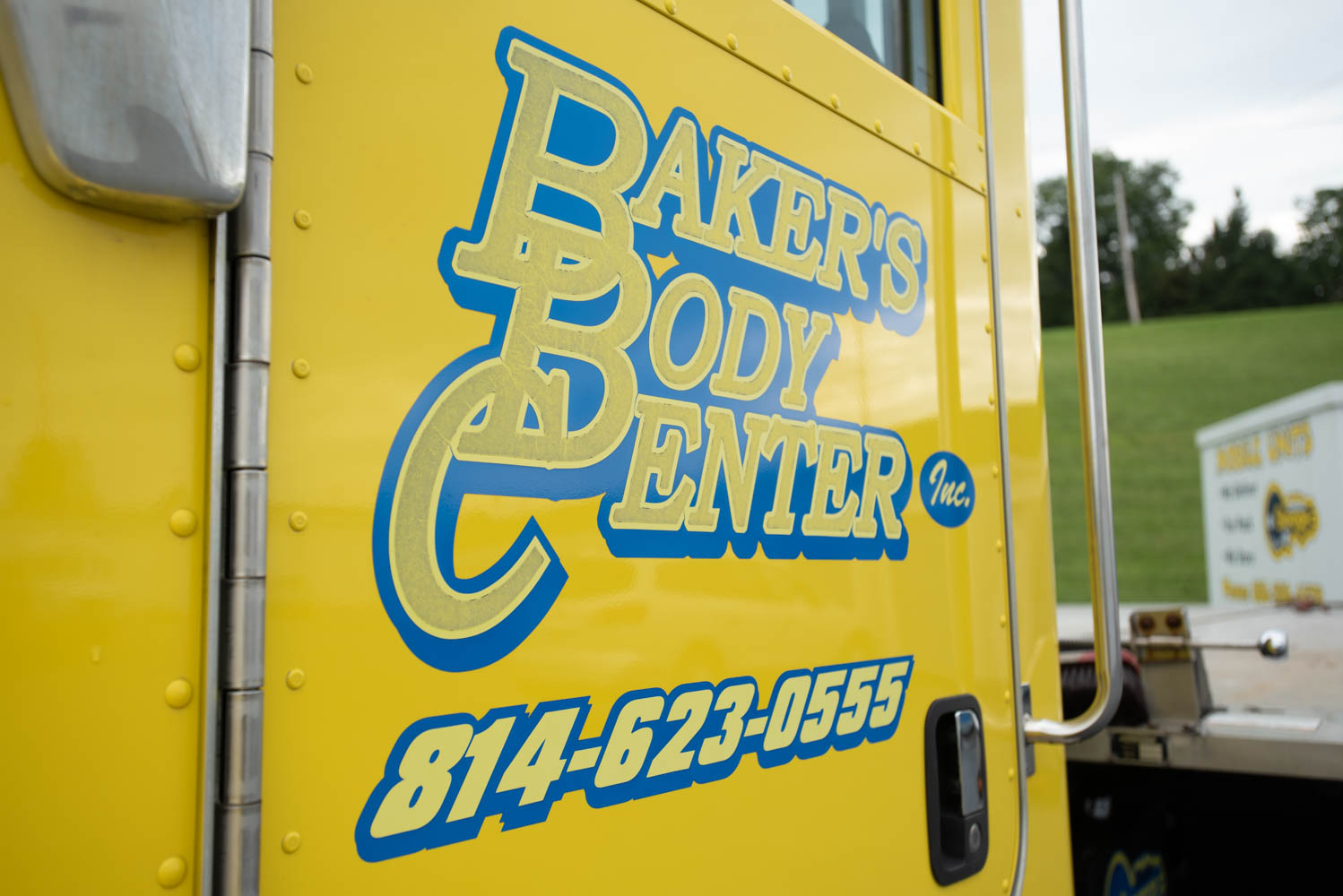 Baker's Body Center logo on rollback truck